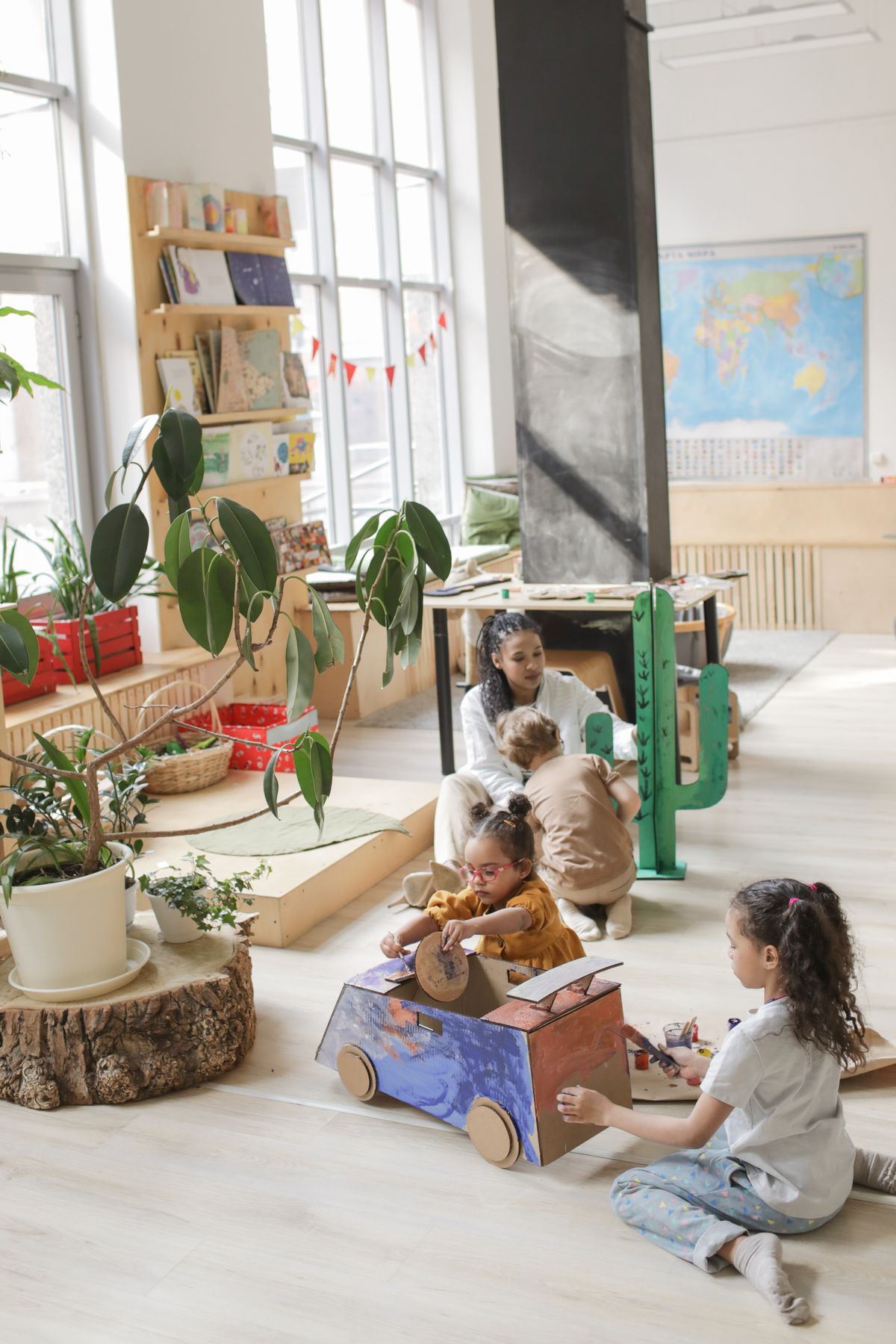 A teacher and children creating together in a classroom